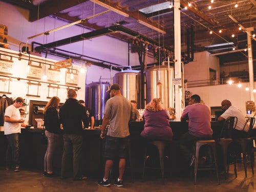 Group of people sitting at a brewery